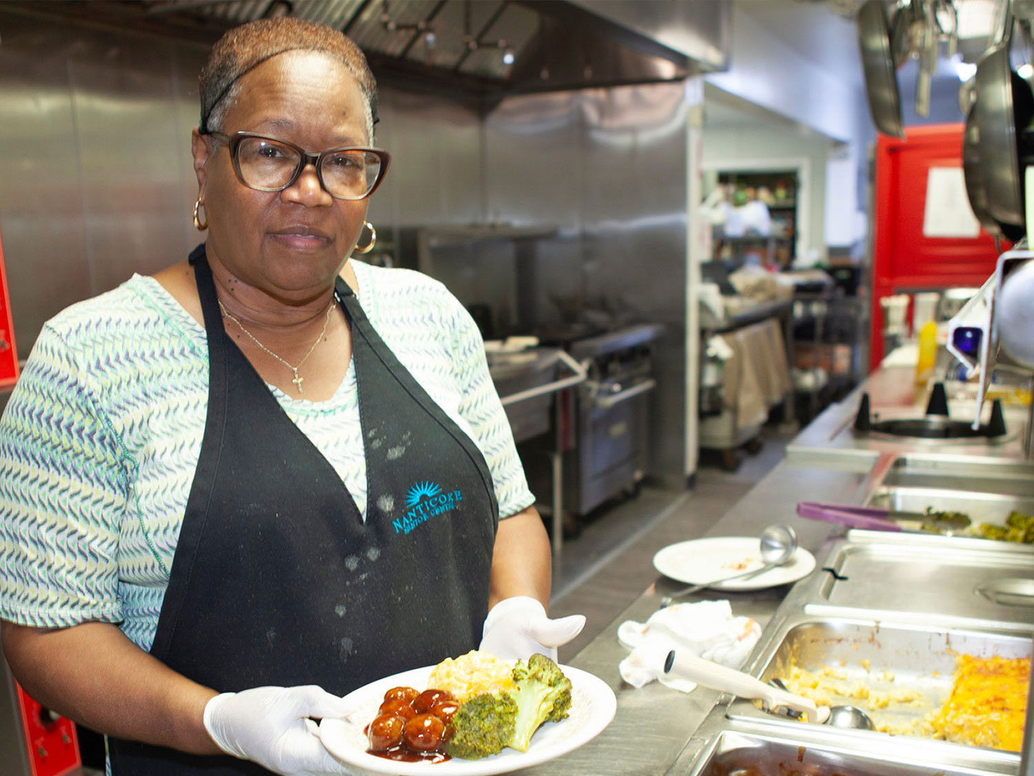 A volunteer at Nanticoke Senior Center serving hot food
