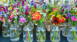 A table full of Beautiful-fresh farmer market-flowers in glass jars